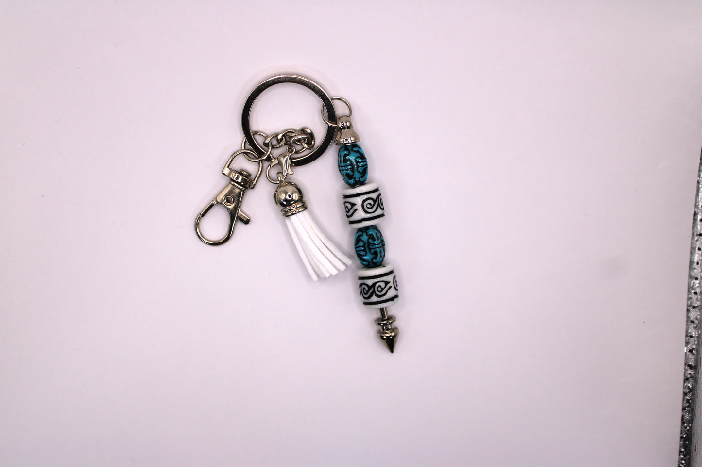 Silver Keychain With White Tassel